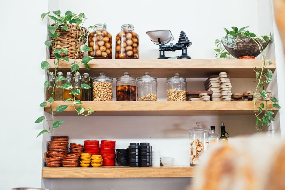 Handcrafted apothecary shelves with glass jars of natural ingredients
